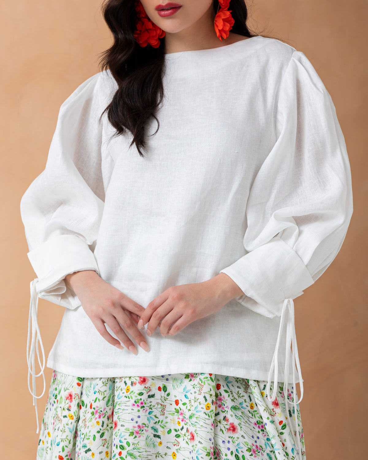 Plain linen top with folds on sleeves tied with bow on cuff