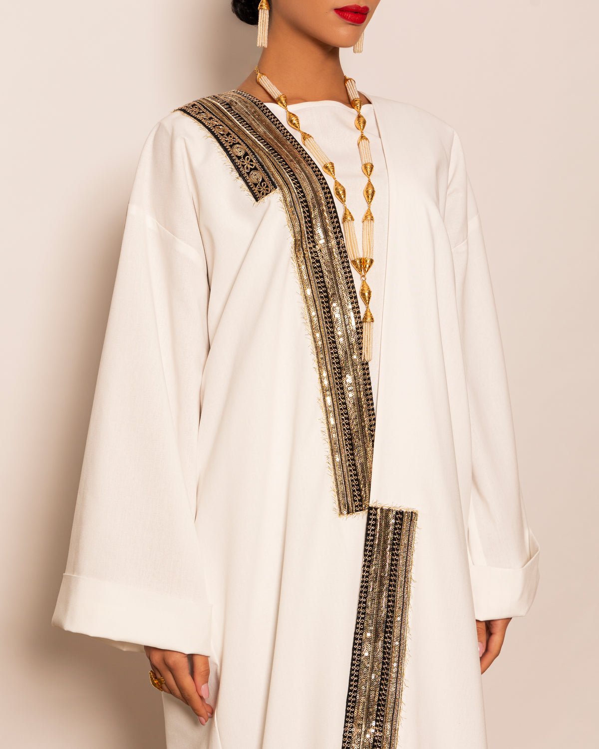 Classic linen abaya with unsymmetrical embellished trimmings